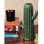Green cactus vase with books and candle