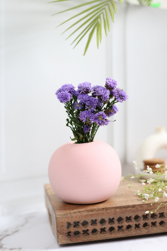 Pink round planter with flowers