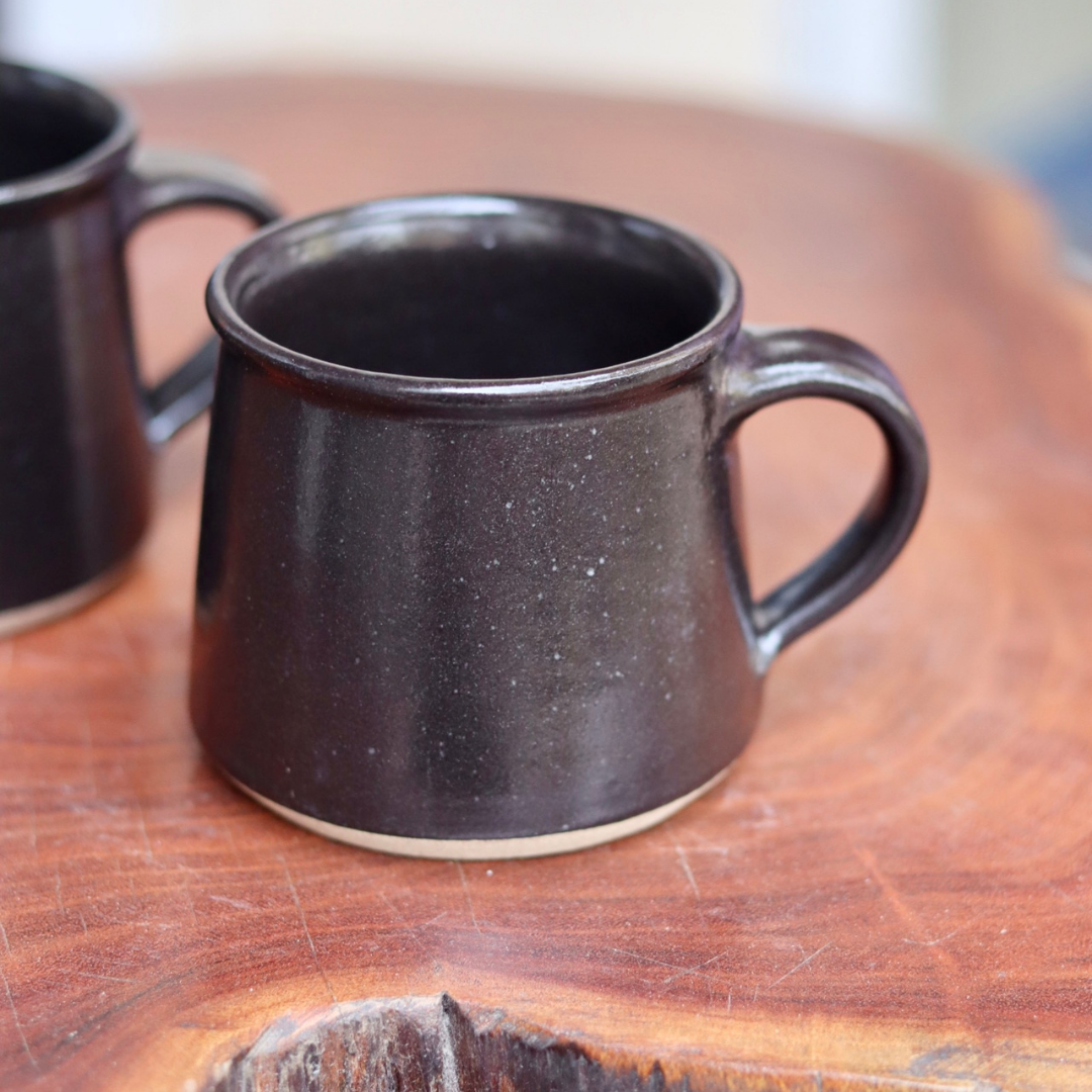 Charcoal coffee mugs on a table