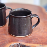 Charcoal coffee mugs on a table