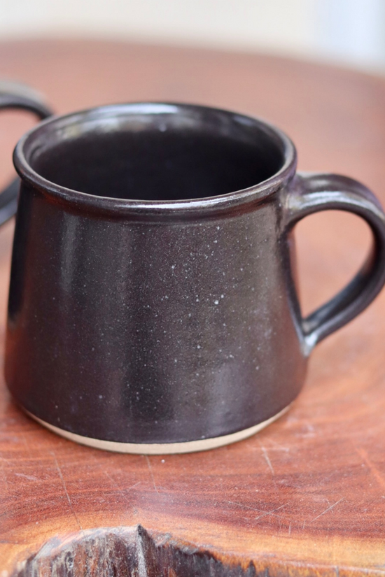 Charcoal coffee mugs on a table