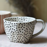Black polka coffee mug closeup shot