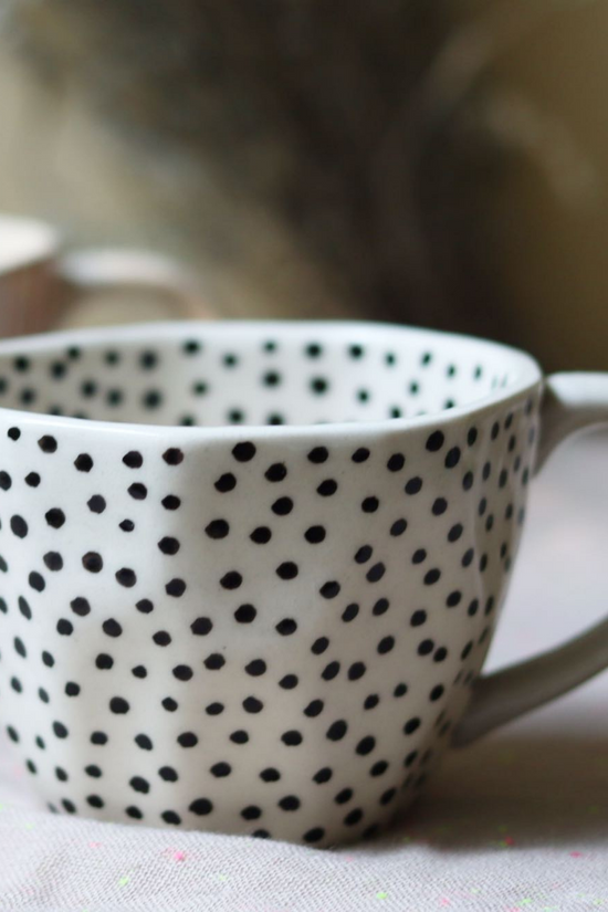 Black polka coffee mug closeup shot