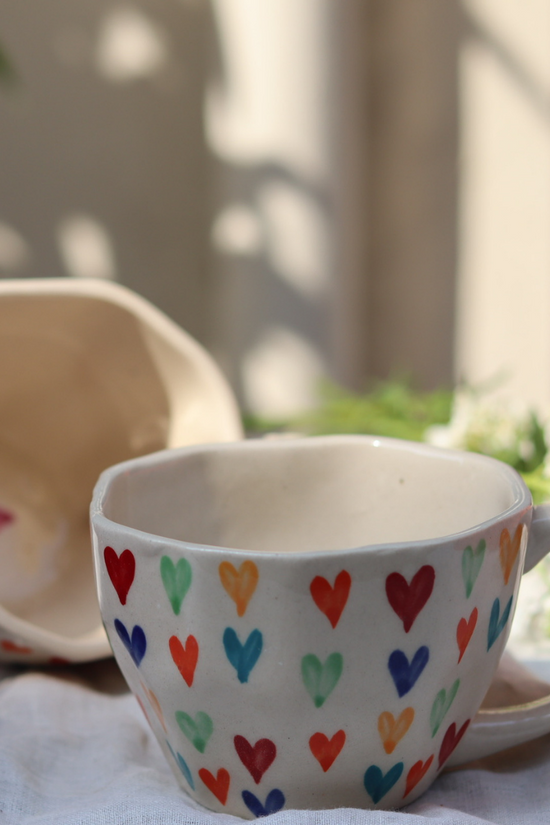 Two multicolor coffee mugs With heart design