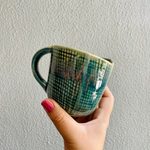 Green bori coffee mug in hand