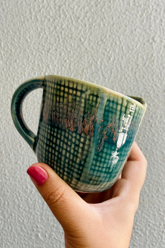 Green bori coffee mug in hand