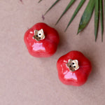 Two red anar shaped salt and pepper shakers
