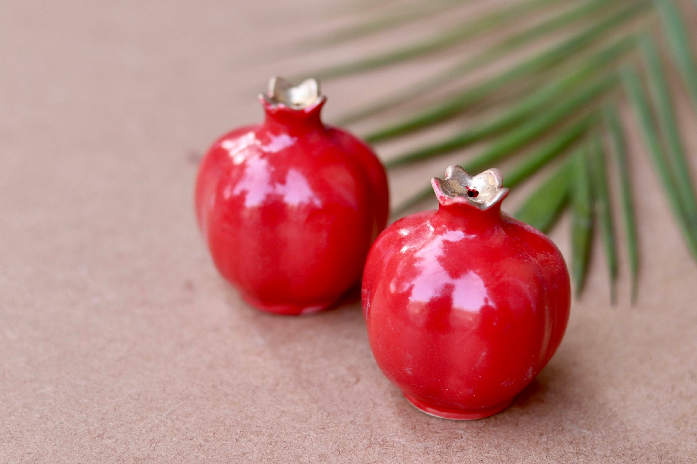 Two red anar salt and pepper shakers