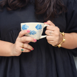 Handmade ceramic cloud coffee mug in hand
